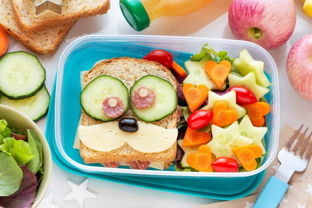 Back to school concept. Lunch box for kids with a cheese and sal