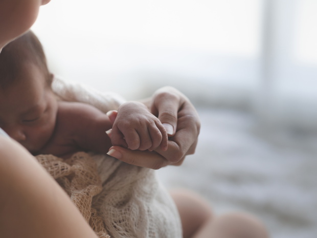 Close up Mother holding hands Asian female newborn baby  and sun