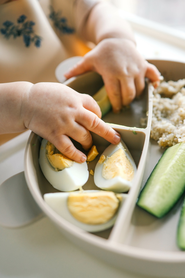 first blw baby food, little baby eating organic vegetables with BLW method. Infant eating healthy food. self feeding