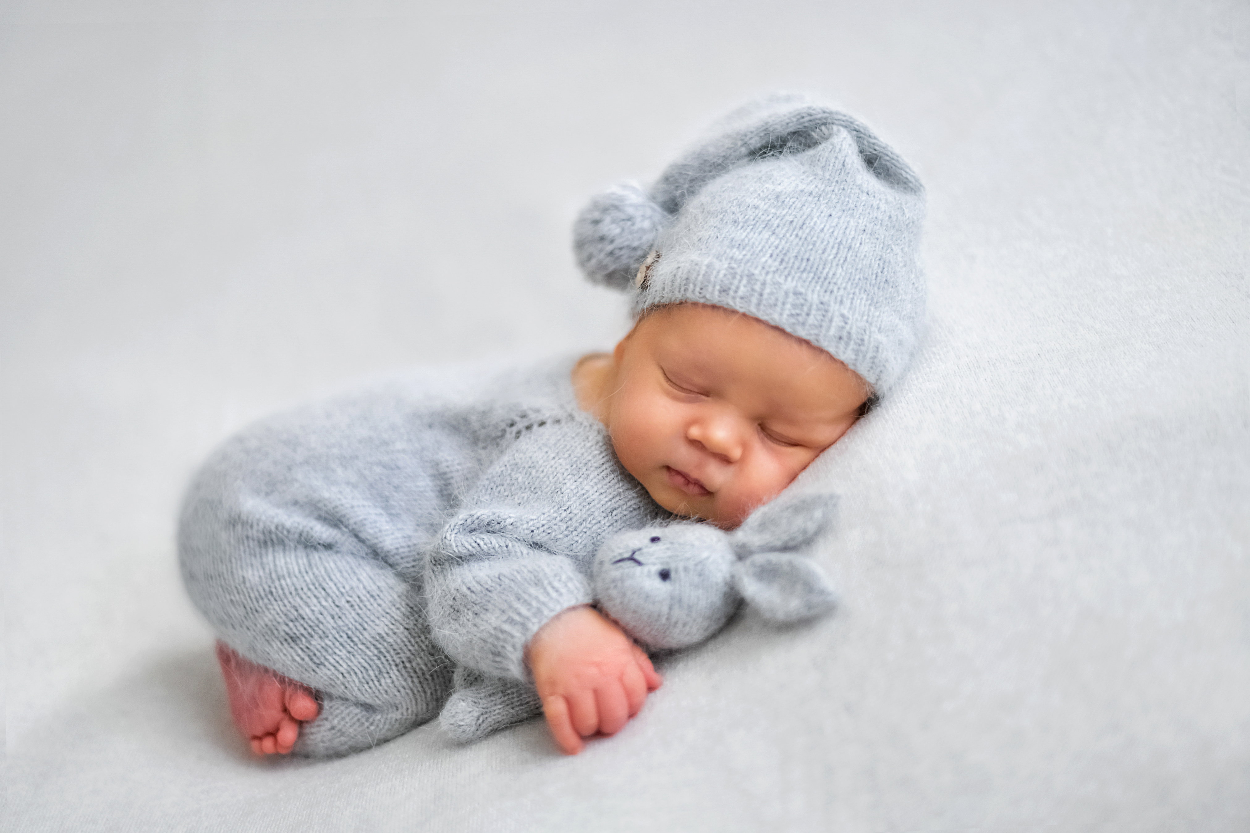 Sleeping newborn boy in the first days of life on white backgrou