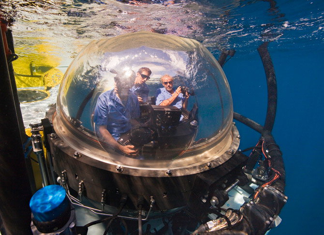 Photographer Brian Skerry, pilot Eli Temime, and author Gregory S. Stone (left to right) start their descent to Las Gemelas seamount aboard the DeepSee in a five-foot sphere with 360-degree views. The submarine, which can drop to 1,500 feet below sea leve