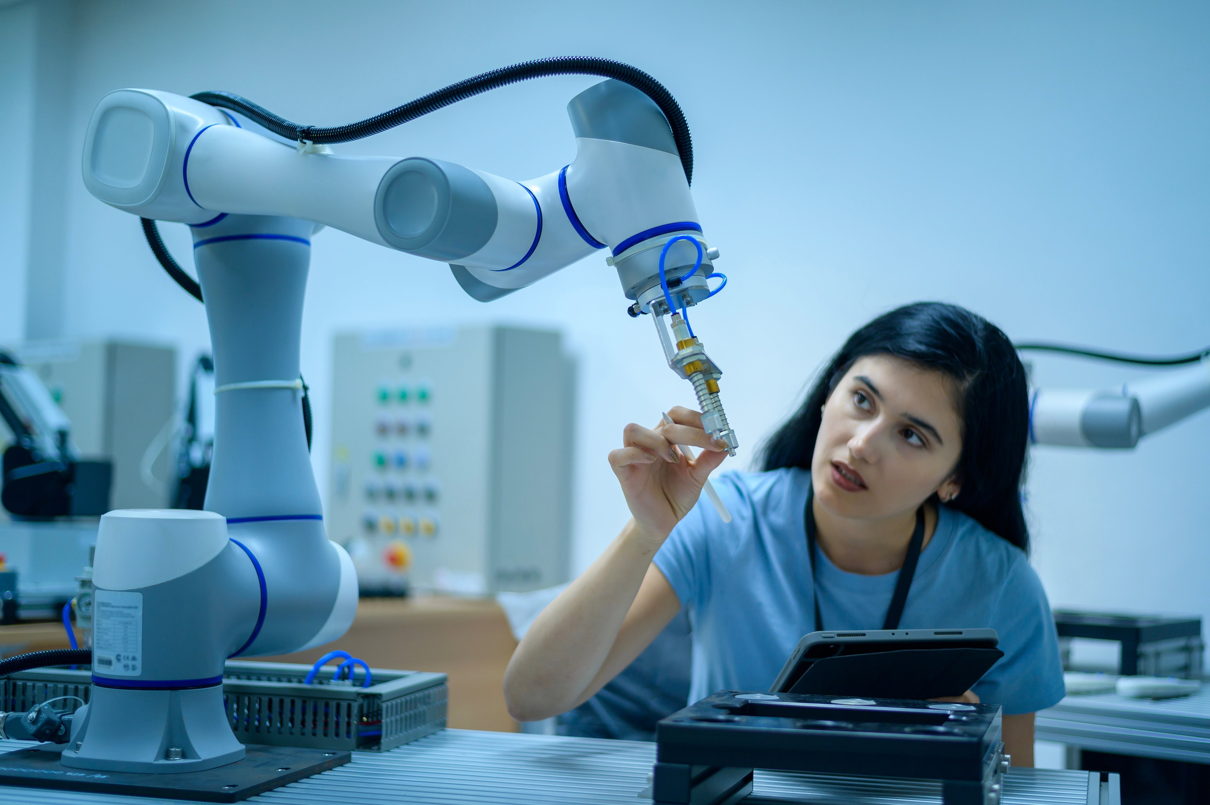 Female,Robotics,Engineer,Working,With,Programming,And,Manipulating,Robot,Hand,