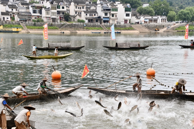 Traditonal fishing in rural China at Yangtze river with two fishermen