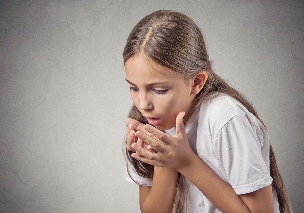 Headshot teenager girl sick about to throw up on grey background