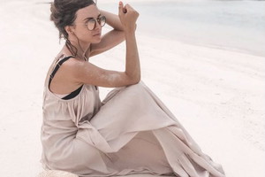 Anna Wendzikowska w jasnej sukience na plaży