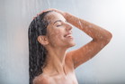 Positive woman taking hot shower