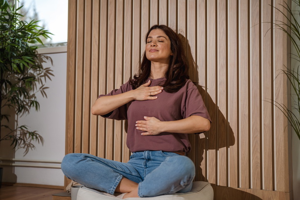 Woman practicing deep breathing exercise during meditation session