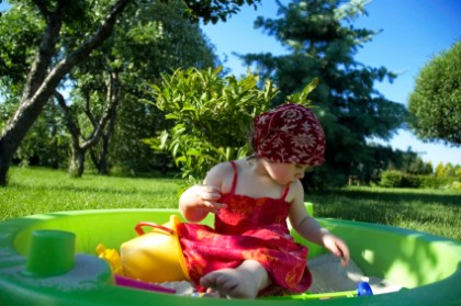 a cute little girl playing in the garden