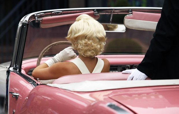 Blond girl model like Marilyn Monroe in car