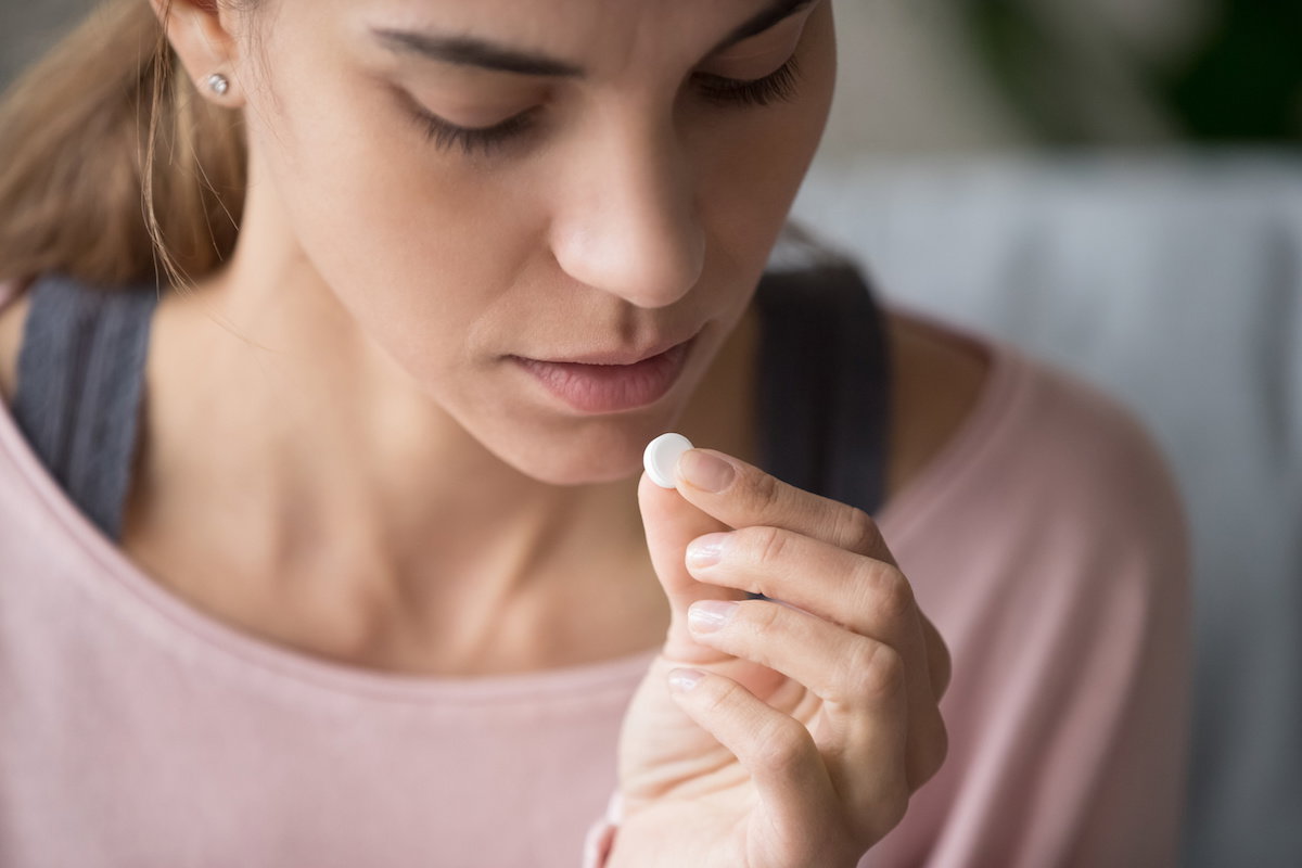 Young woman think about taking emergency medicine