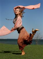 blond woman dancing on the beach