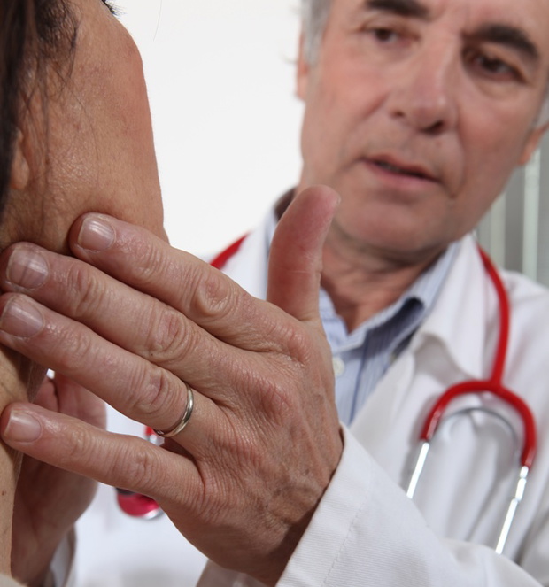 Doctor examining his patient's glands