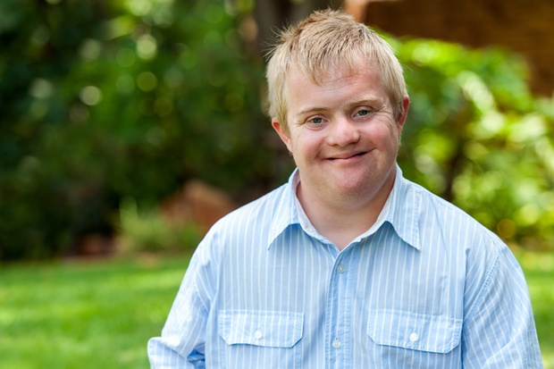 Smiling handicapped boy outdoors.
