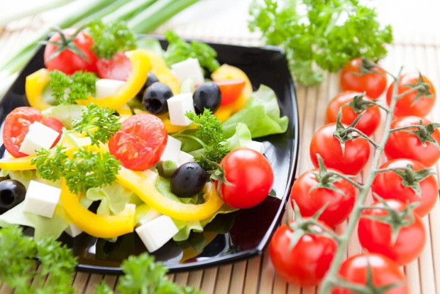 Greek salad and a sprig of cherry tomatoes, close up