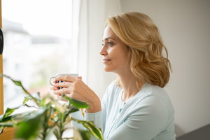 Beautiful Caucasian middle aged woman relaxing at home