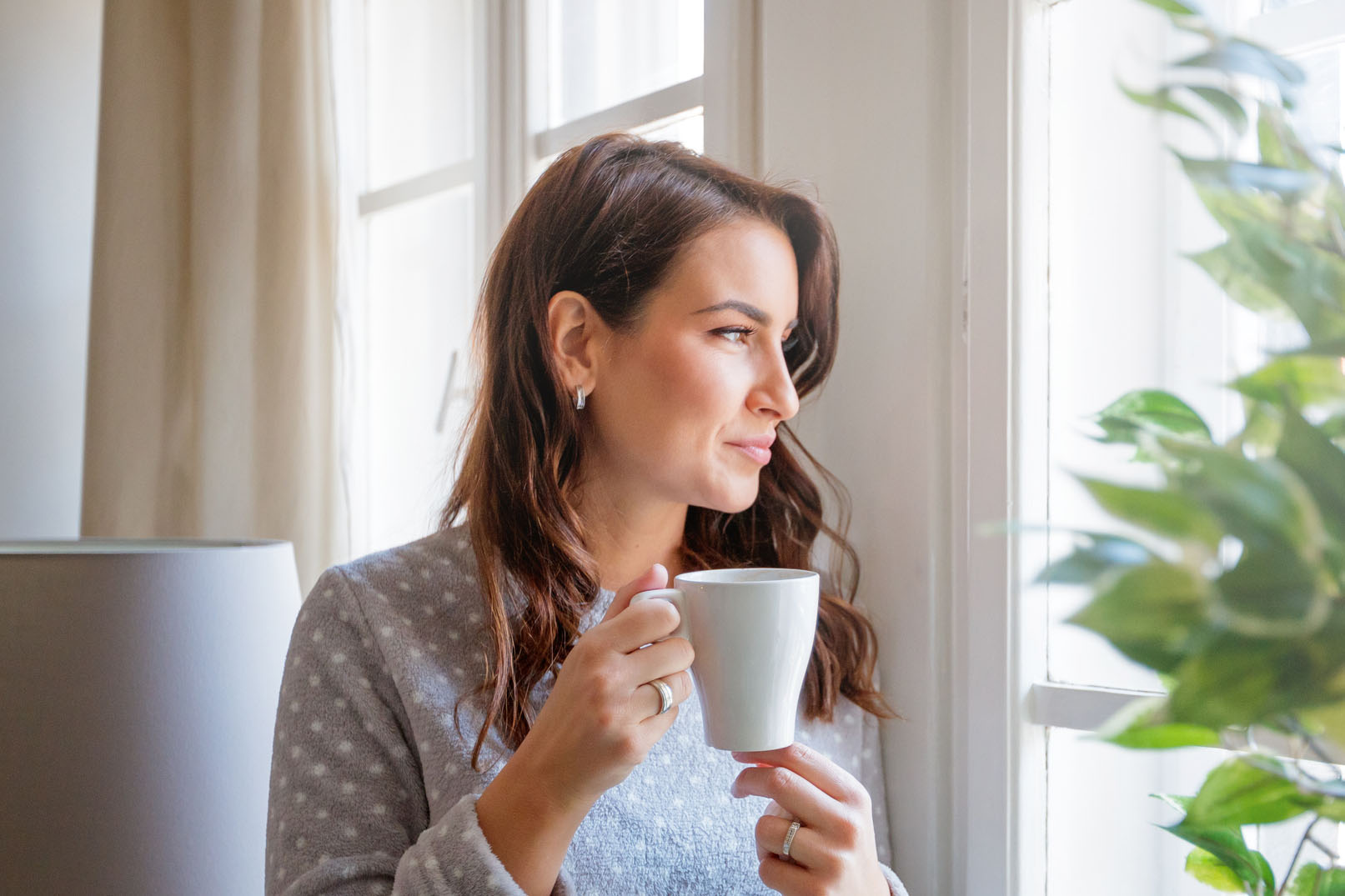 Having coffee and looking through window