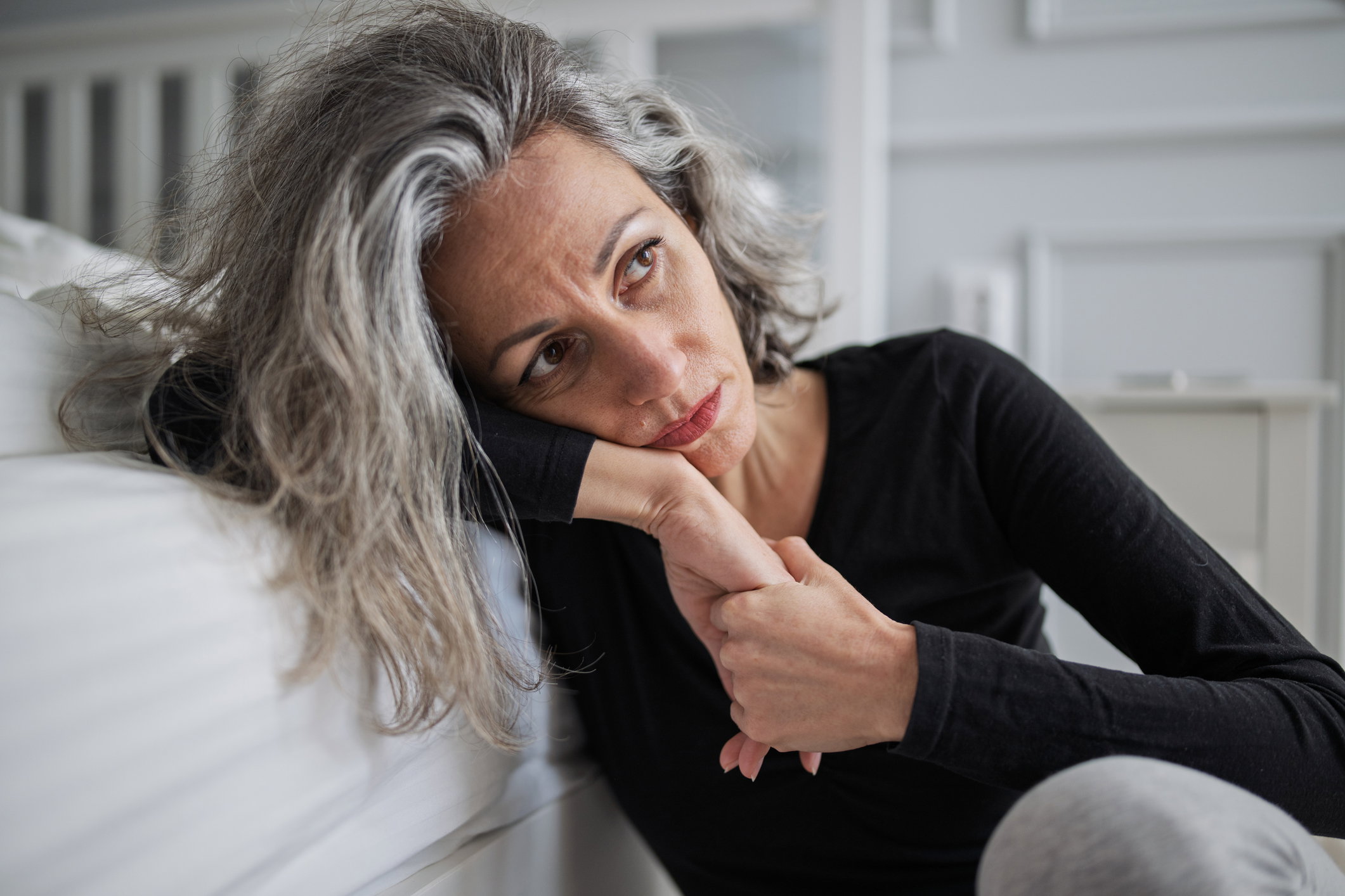 Mid adult woman struggling with mental health problems.
