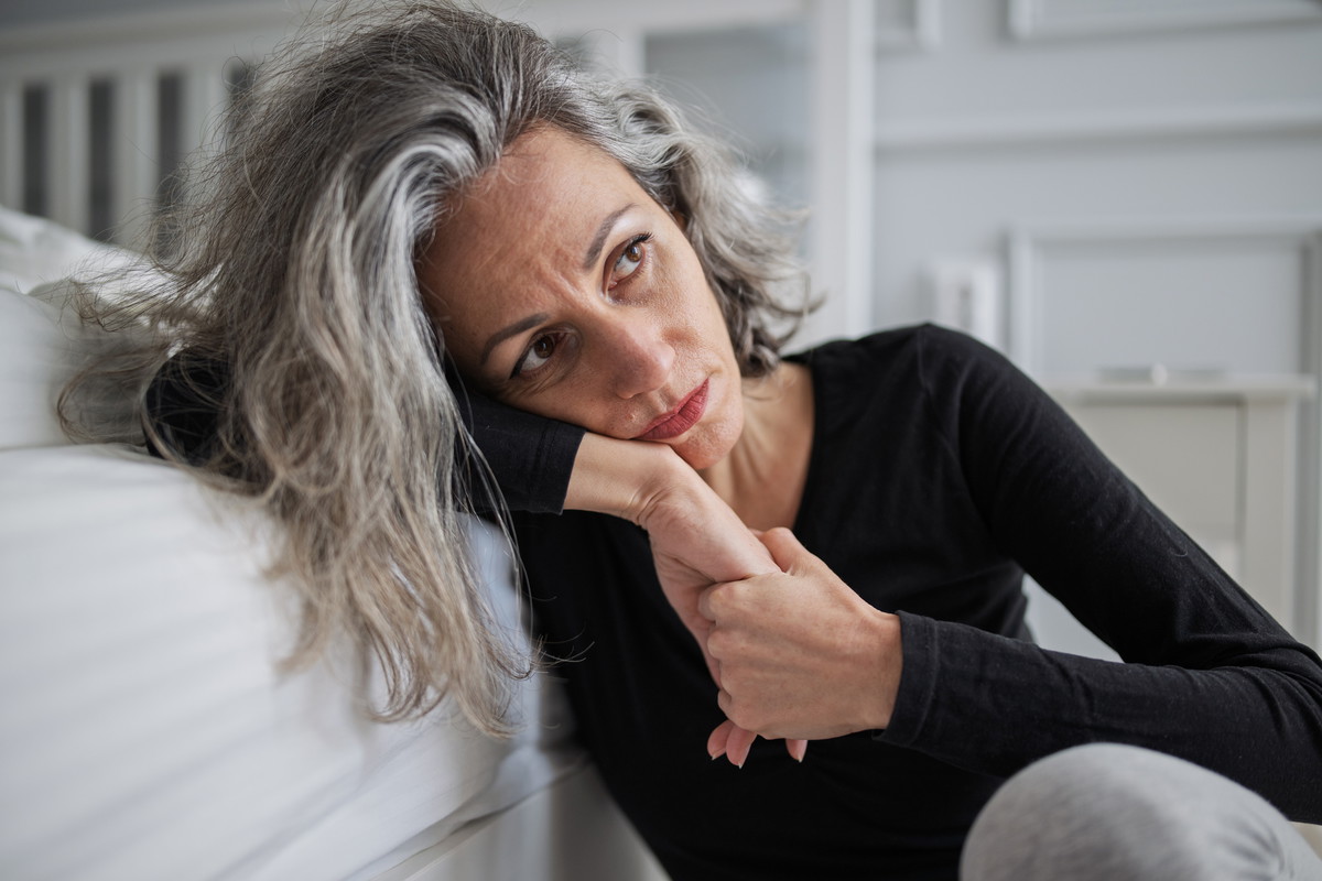 Mid adult woman struggling with mental health problems.