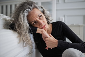 Mid adult woman struggling with mental health problems.