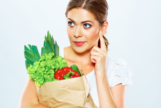 thinking woman close up portrait with green food