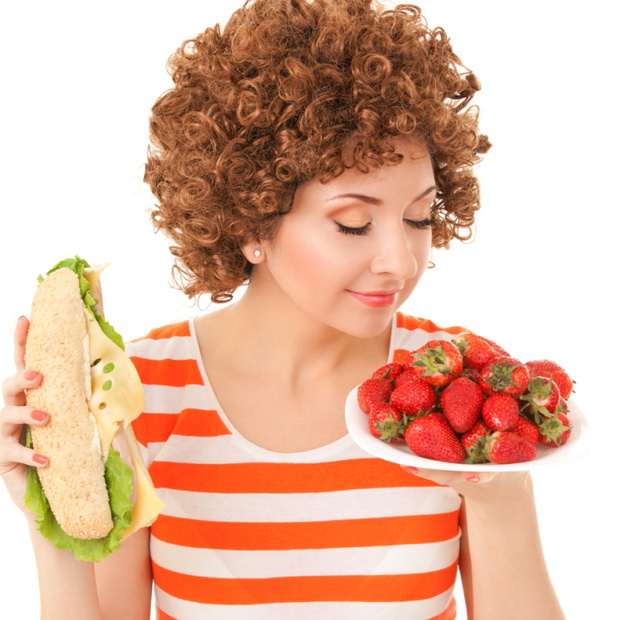 Fun woman with strawberry and sandwich on the white background