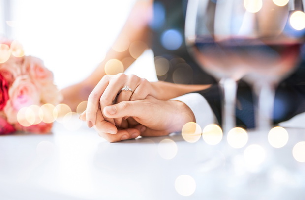 engaged couple with wine glasses