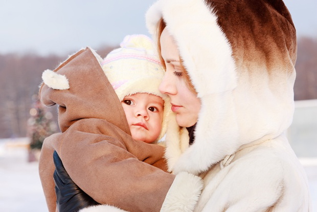 Woman with baby on her hand in winter