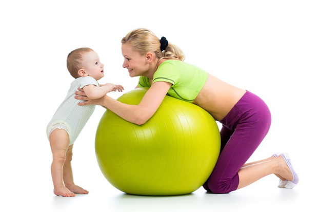 mother with baby having fun with gymnastic ball