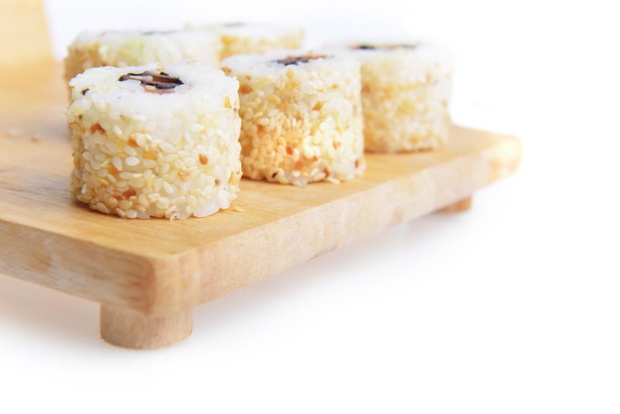 tasty fresh uramaki with tuna on wooden plate