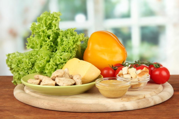 Ingredients for Caesar salad on bright background