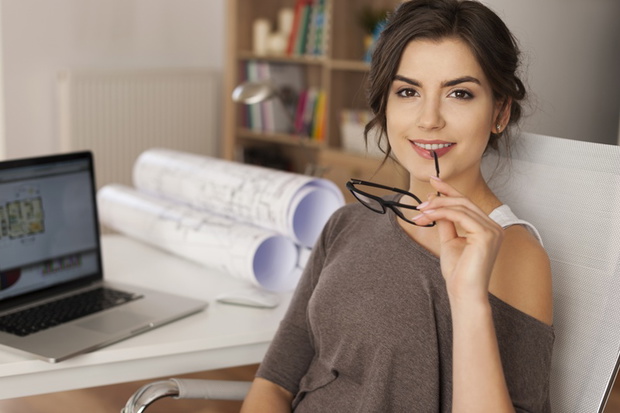 Portrait of beautiful female architect in place of work