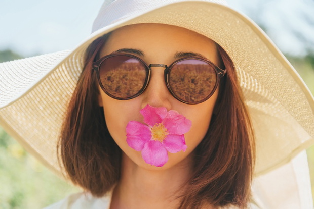Portrait of beautiful woman with flower