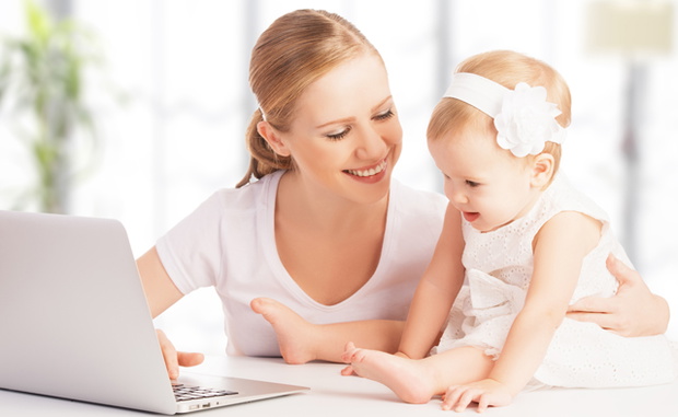 mother and baby at home using laptop computer