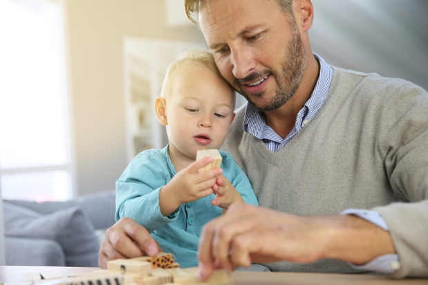 Daddy with 2-year-old boy playing with wooden blocks