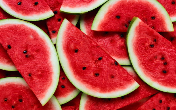 A large number of cut slices of watermelon