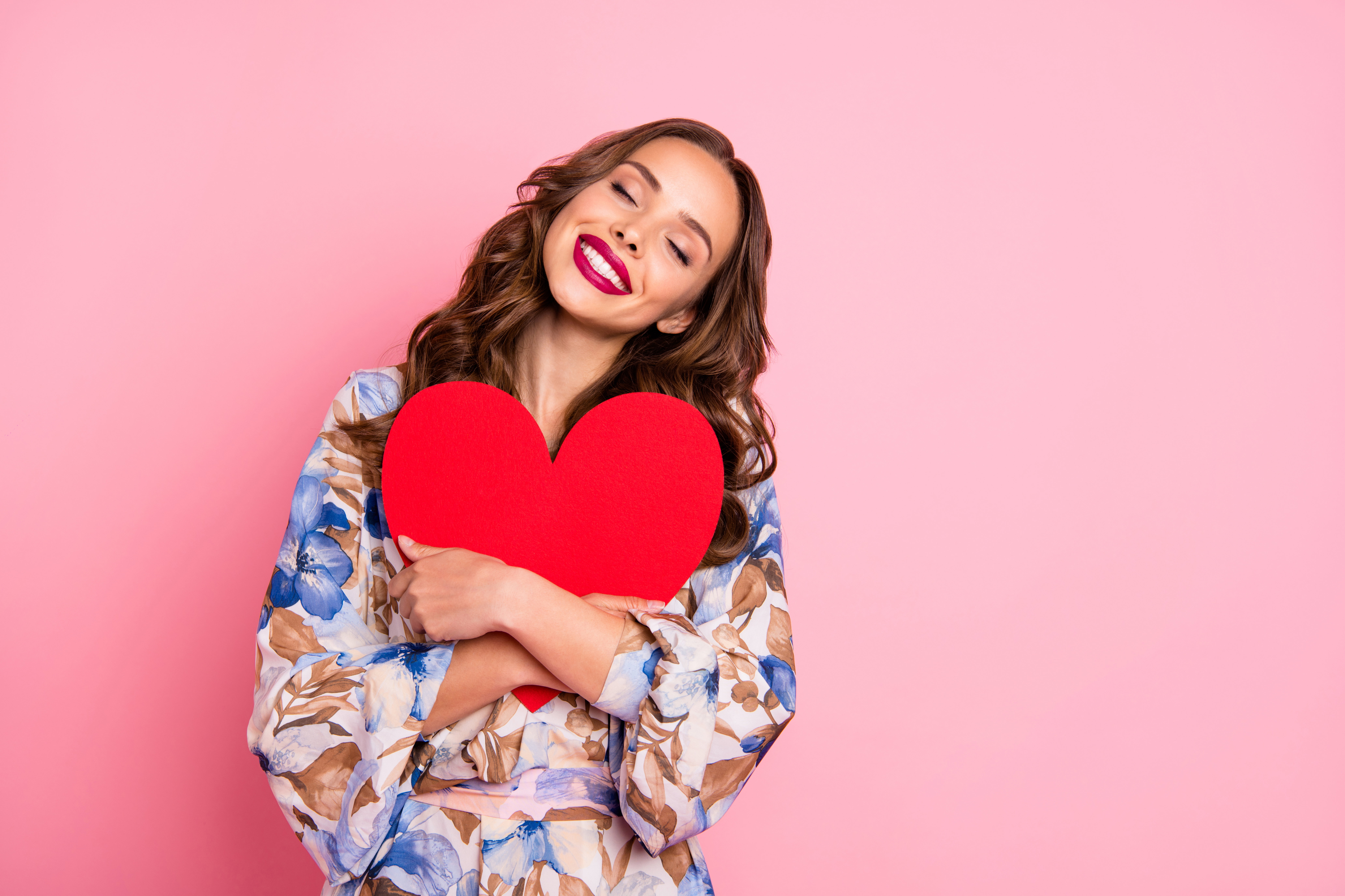 Portrait of her she nice-looking attractive lovely sweet cheerful cheery wavy-haired girl embracing large big heart 14 February life isolated over pink pastel background