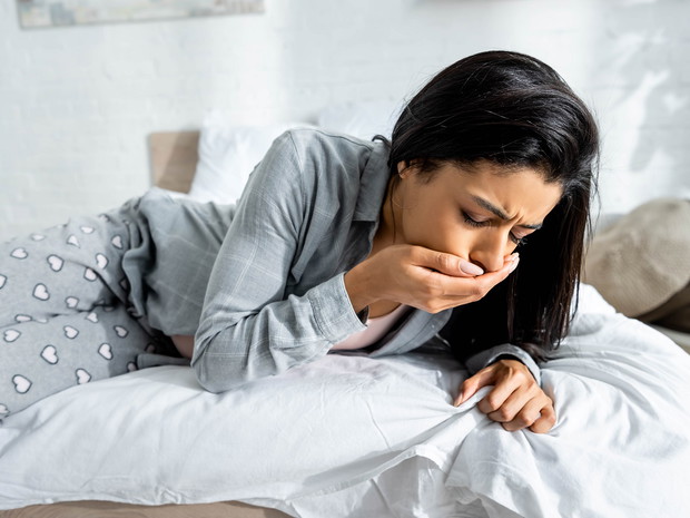 pregnant african american woman having toxicosis vomit in apartment