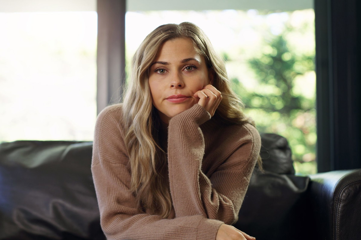 Portrait of bored woman on a living room sofa watching a boring tv show, movie or video. University or college student on school break with a free schedule sitting in a house, apartment or home