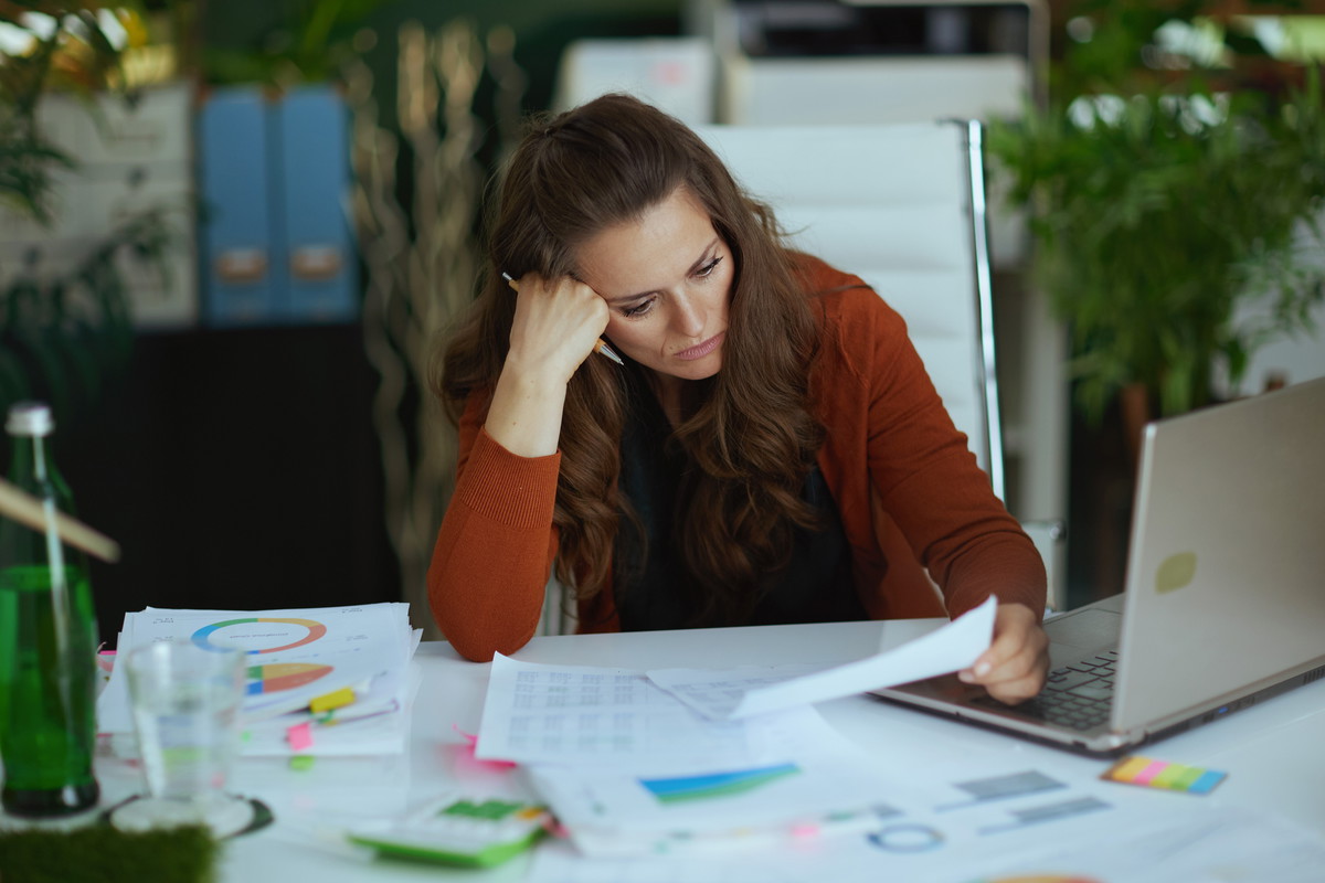 business owner woman in green office working with documents