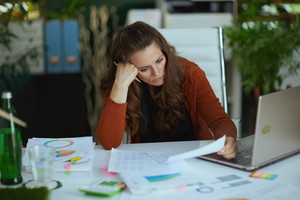 business owner woman in green office working with documents