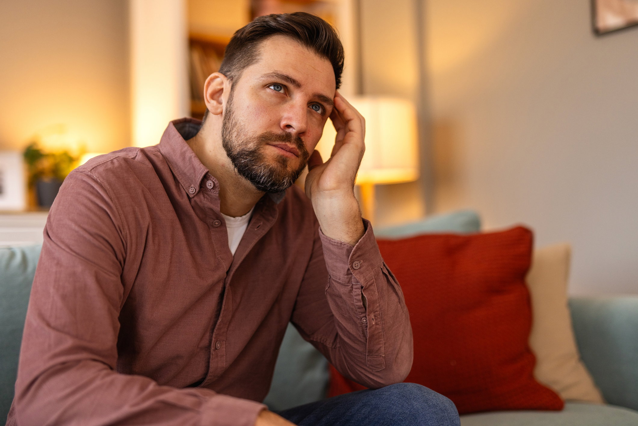 A portrait of a man with a worried expression, conveying a sense of concern or uncertainty. Emotions of stress, anxiety, or deep thought, mental health, stress, and human emotions