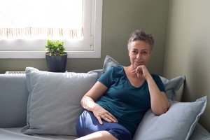 Portrait of smiling mature woman sitting on sofa