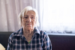 Portrait of desperate senior woman at home.