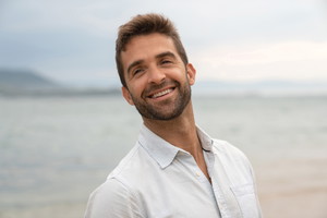 Portrait of a happy man at the beach