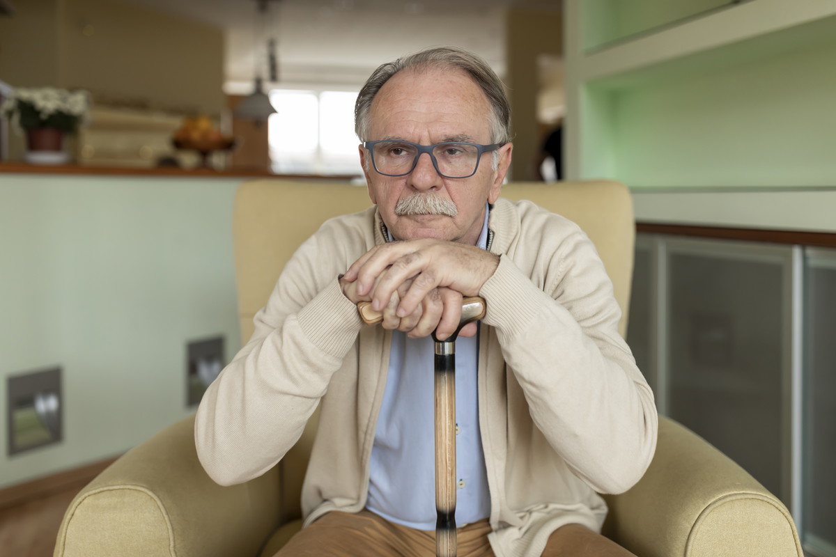 Portrait of a Senior Man with Walking Cane, Looking Worried, and Sad.