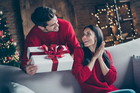 Portrait of his he her she nice attractive lovely sweet charming cheerful cheery glad married spouses guy giving latin hispanic girl eve noel gift in decorated loft industrial style interior
