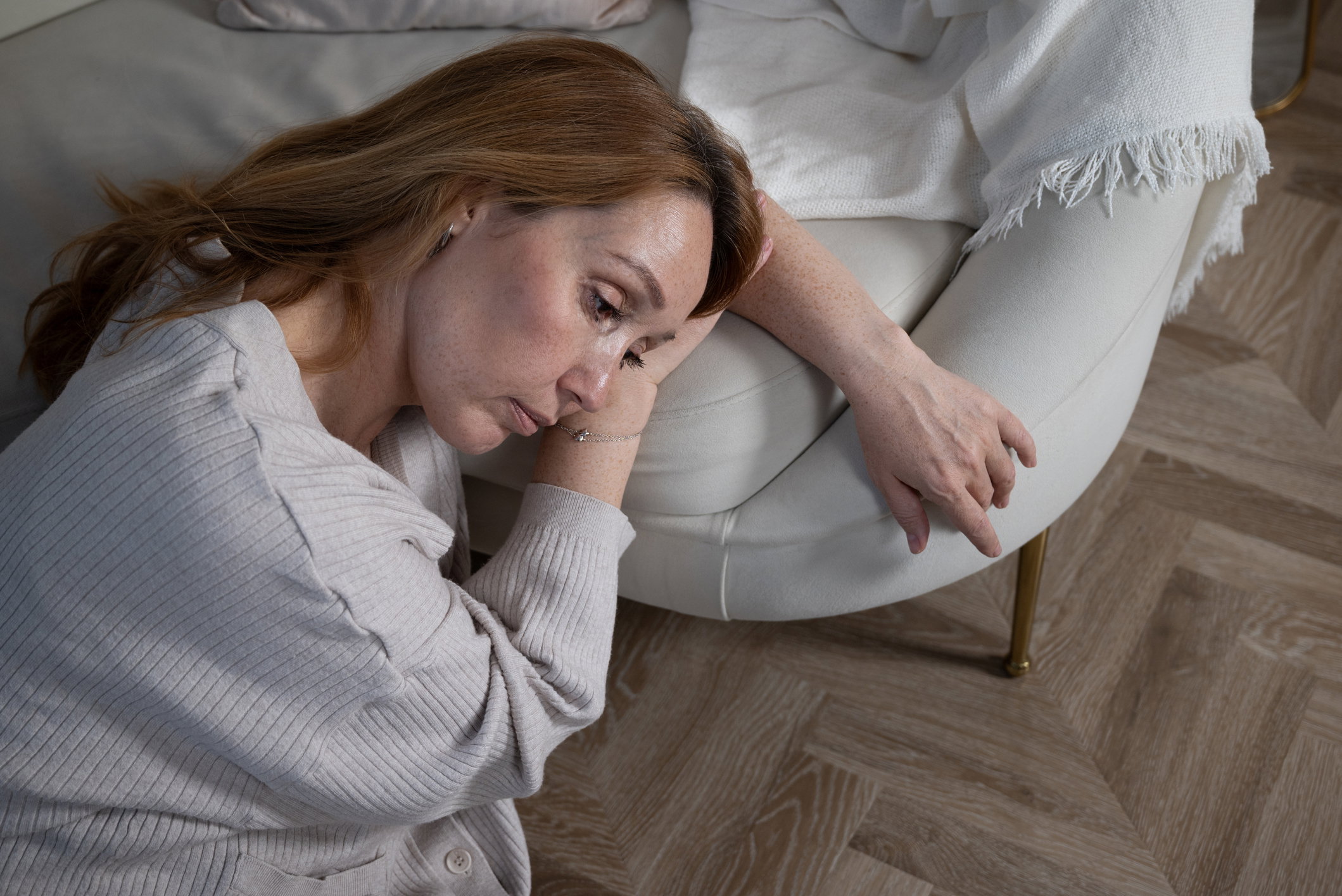 Moments of reflection: A middle-aged red-haired woman in a home setting, lost in thought