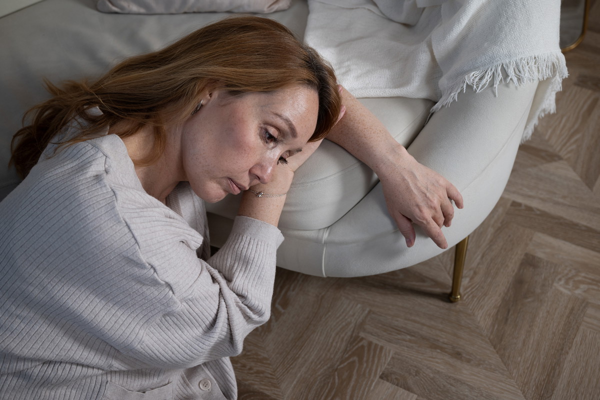 Moments of reflection: A middle-aged red-haired woman in a home setting, lost in thought
