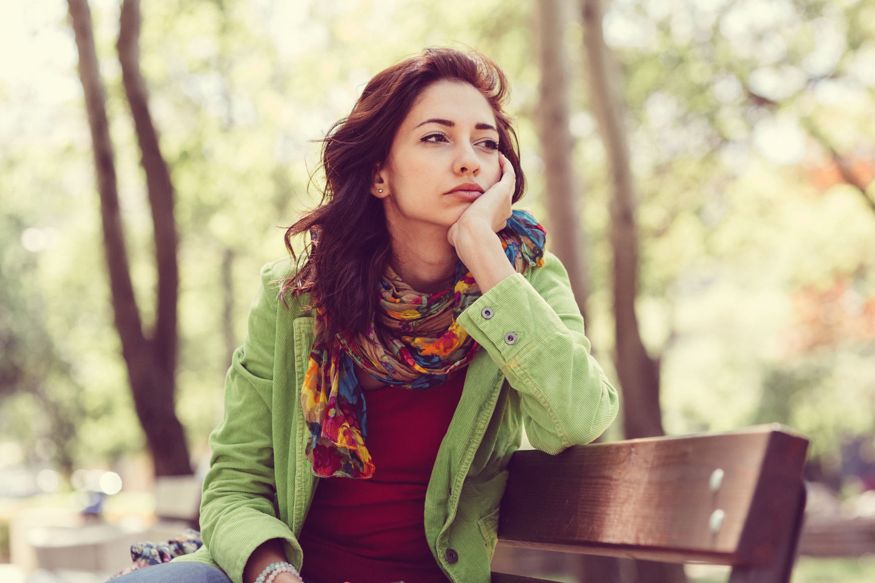 Unhappy girl sitting at bench
