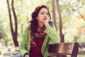 Unhappy girl sitting at bench